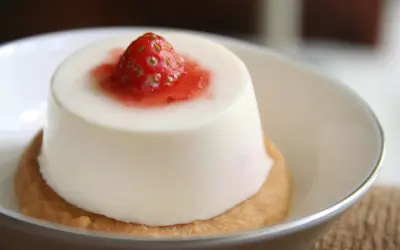Panna cotta à la fraise sur un biscuit. Si elle est trop liquide, pas de panique, voici comment rattraper une panna cotta trop liquide.