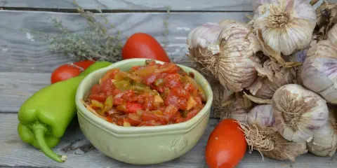 Bol de piperade recette avec poivrons verts, tomates et ail.