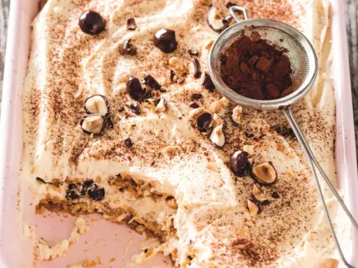 Un tiramisu chocolat blanc crémeux, garni de noisettes et de cacao saupoudré. Un délice à savourer !