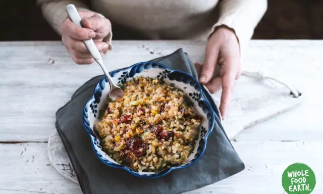 Un bol de freekeh recette, garni de canneberges et de légumes, prêt à être dégusté.