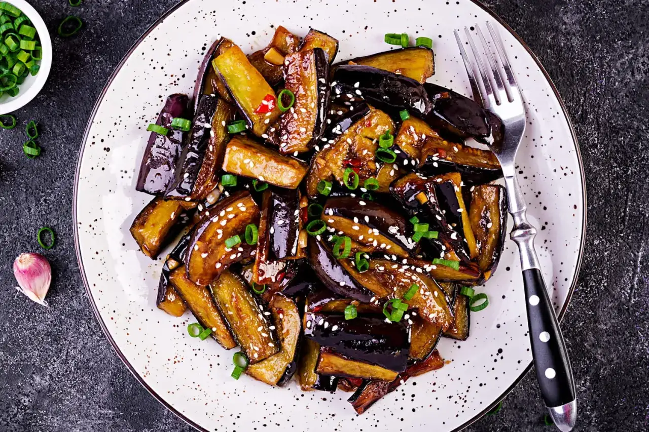 Aubergines laquées, garnies de graines de sésame et d'oignons verts. Une recette simple et savoureuse pour sublimer ce légume.
